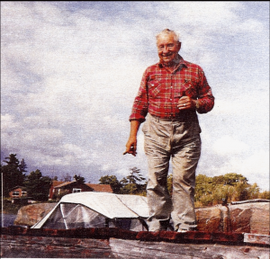 Bill Michaud standing on his dock. His small Thundercraft boat is partially visible in the background.